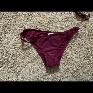 Maroon bikini bottom with keyhole cutouts on sides